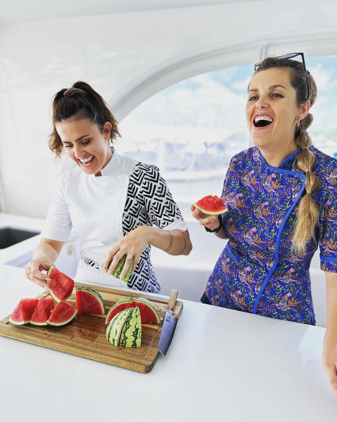 Funky Chef Founder Hannah Staddon with Chef Tzarina laughing and eating watermelon.